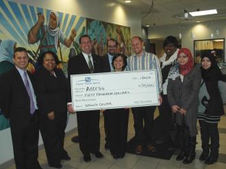 Representatives from Fifth Third Bank present a $50,000 check to ACCESS Growth Center employees.