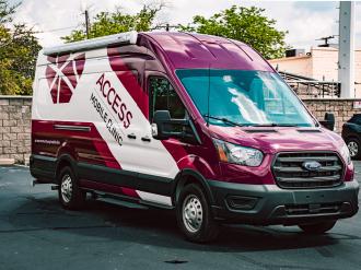 Image shows a deep red colored mobile health van