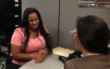 Woman receiving assistance counseling from ACCESS professional. 