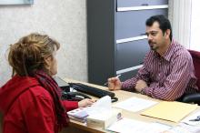ACCESS professional giving translation services to a woman.