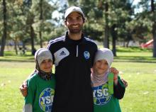 Volunteer coach with two children.