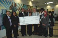 Representatives from Fifth Third Bank present a $50,000 check to ACCESS Growth Center employees.
